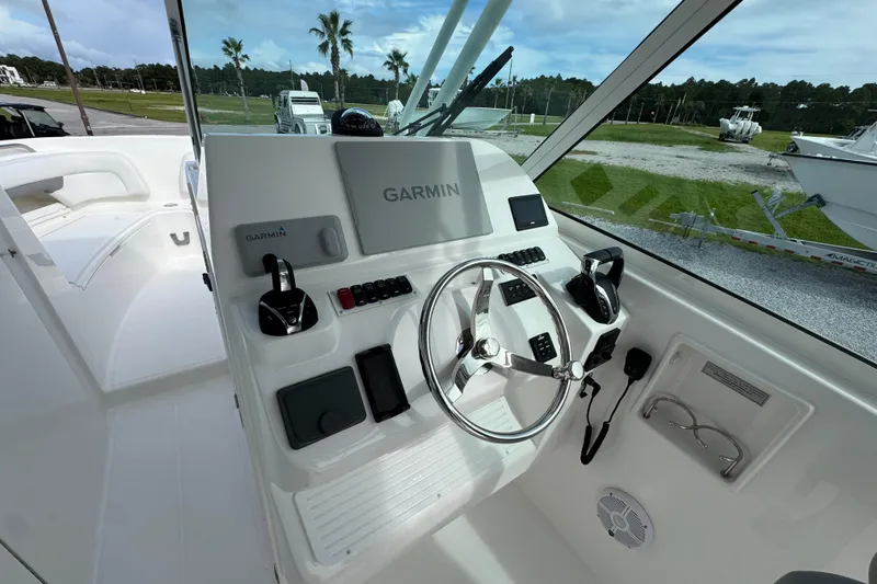 Slide: The Image of 2023 Albemarle 27 Dual Console boat helm with Garmin navigation system and steering wheel. - 22