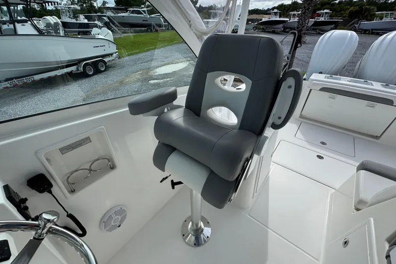 Slide: The Image of Captain's chair on 2023 Albemarle 27 Dual Console boat, featuring sleek design and modern controls. - 24