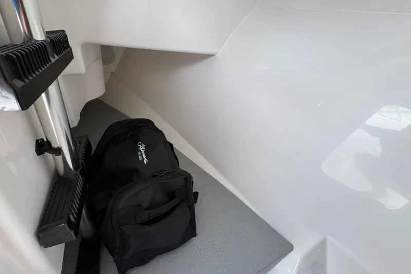 Slide: The Image of 2023 Albemarle 27 Dual Console interior with black bag and cleaning tools. - 28