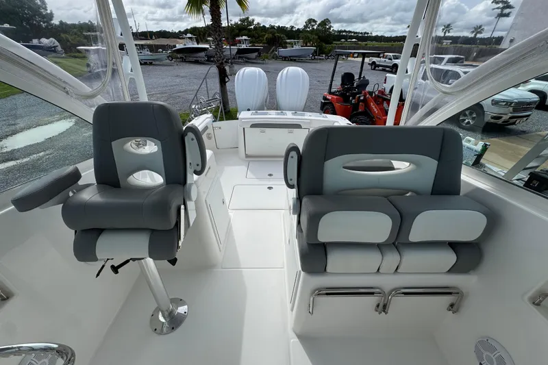 Slide: The Image of 2023 Albemarle 27 Dual Console boat interior with gray and white seating. - 30
