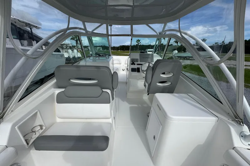 Slide: The Image of 2023 Albemarle 27 Dual Console boat interior with seating and helm, showcasing modern design. - 31