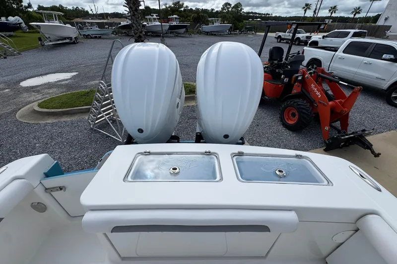 Slide: The Image of 2023 Albemarle 27 Dual Console boat with dual engines in a marina setting. - 36