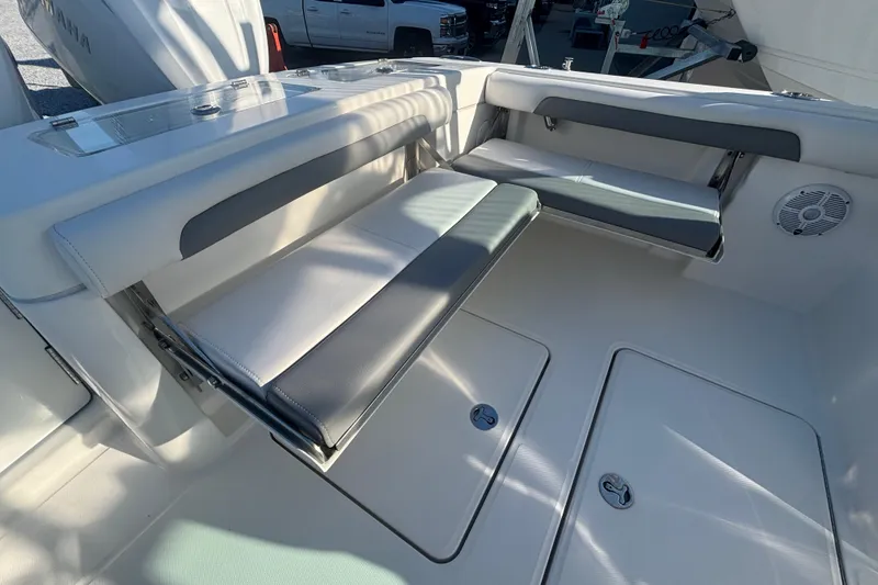 Slide: The Image of 2023 Albemarle 27 Dual Console boat interior with foldable seating and storage compartments. - 40