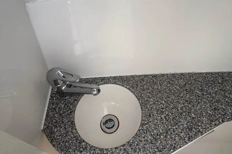 Slide: The Image of 2023 Albemarle 27 Dual Console boat sink with chrome faucet and speckled countertop. - 43