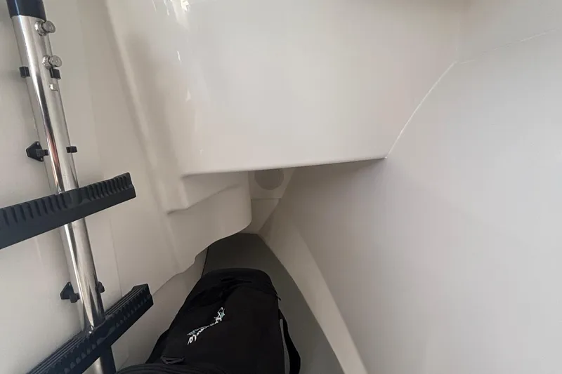 Slide: The Image of Interior of 2023 Albemarle 27 Dual Console boat, featuring storage space and ladder. - 44