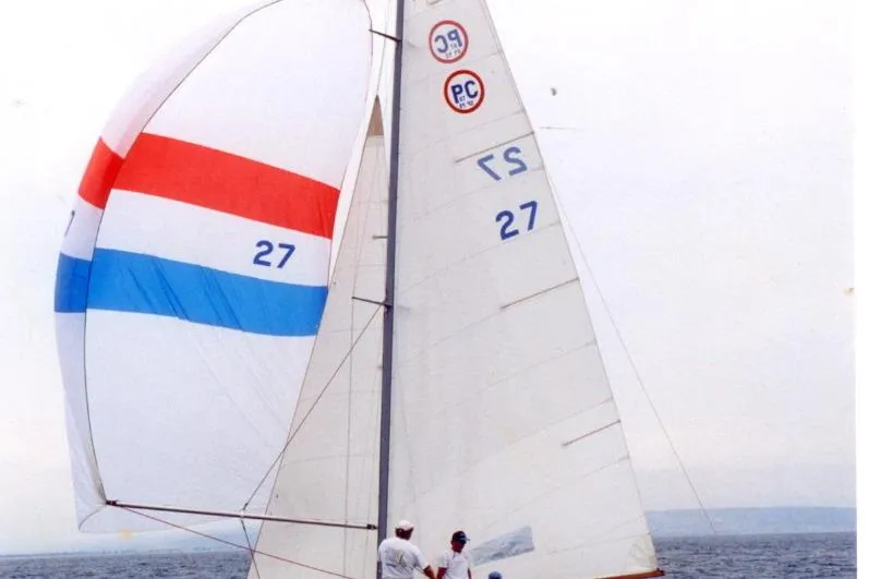 Slide: The Image of Sailing yacht Kettenburg Pacific Class 1937 with colorful spinnaker on open water. - 4
