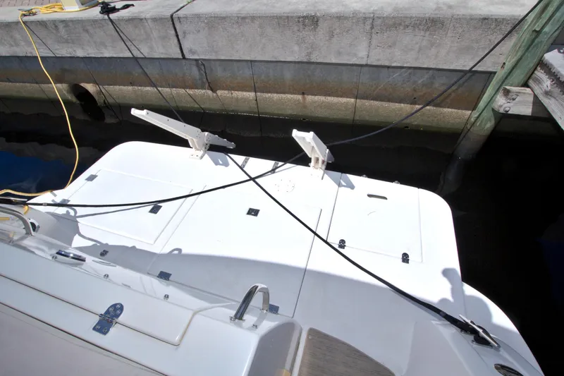 Slide: The Image of 2004 Cruisers Yachts 370 Express docked, showing rear deck and mooring lines. - 10