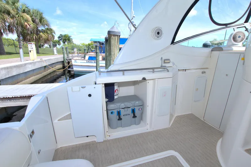 Slide: The Image of 2004 Cruisers Yachts 370 Express interior with storage and dockside view. - 14