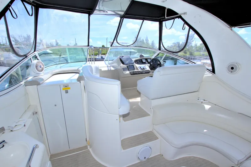Slide: The Image of 2004 Cruisers Yachts 370 Express cockpit with white seating and modern controls. - 15