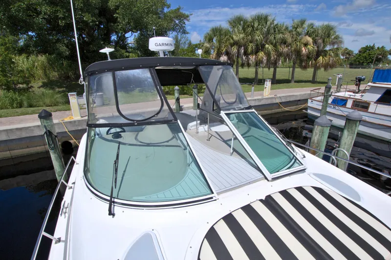 Slide: The Image of 2004 Cruisers Yachts 370 Express docked, featuring sleek design and Garmin navigation system. - 25