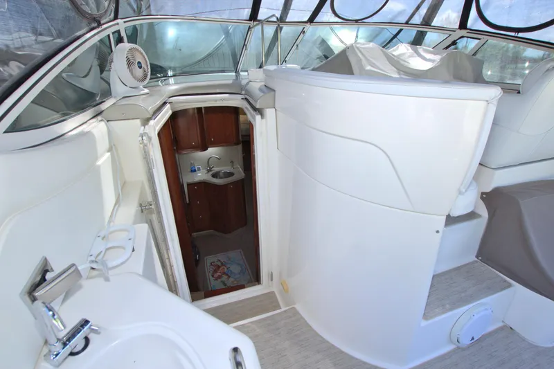 Slide: The Image of 2004 Cruisers Yachts 370 Express interior with sink and cabin entrance. - 29
