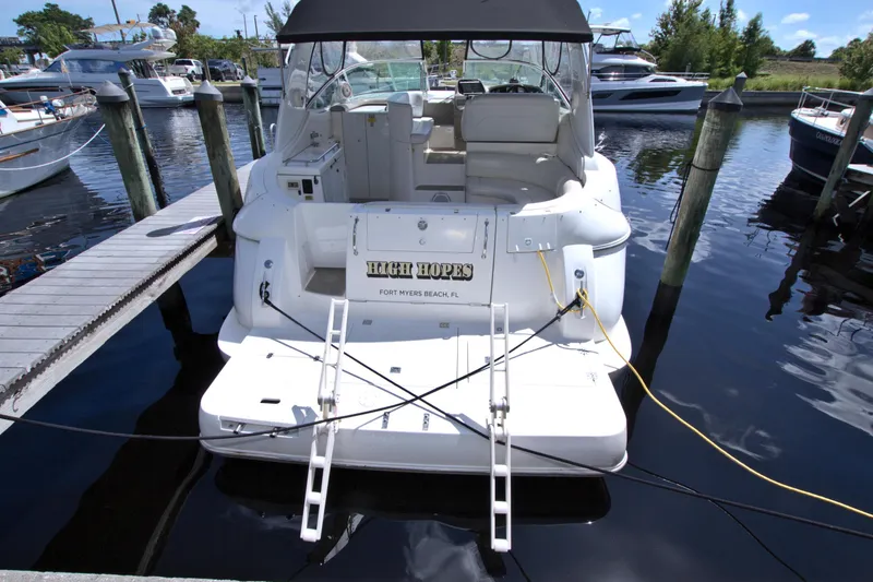 Slide: The Image of 2004 Cruisers Yachts 370 Express docked, rear view with "High Hopes" nameplate. - 3