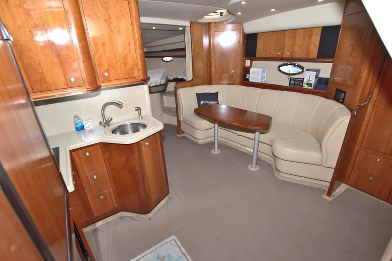 Slide: The Image of 2004 Cruisers Yachts 370 Express interior with kitchenette and seating area. - 30
