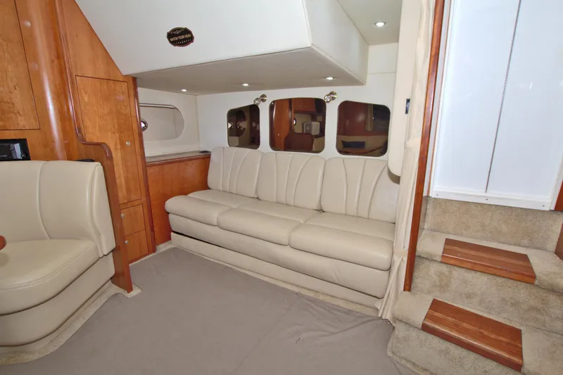 Slide: The Image of Interior of 2004 Cruisers Yachts 370 Express with beige seating and wooden accents. - 32