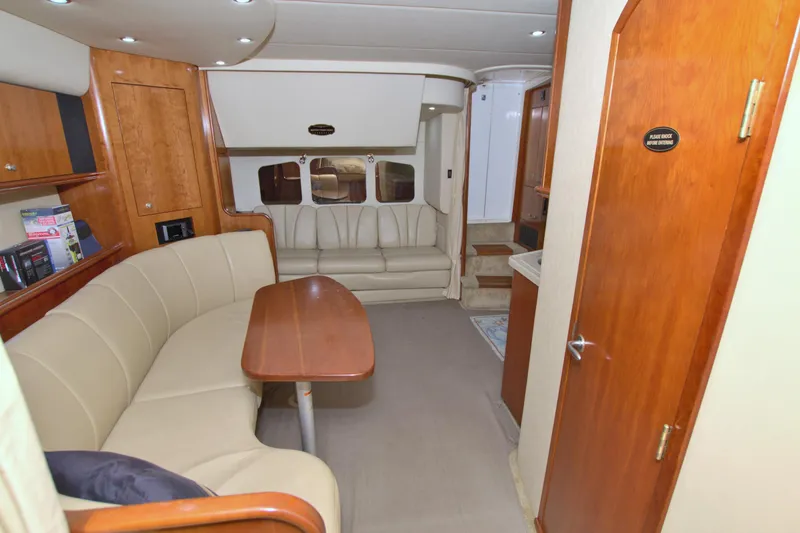 Slide: The Image of 2004 Cruisers Yachts 370 Express interior with beige seating and wooden accents. - 39