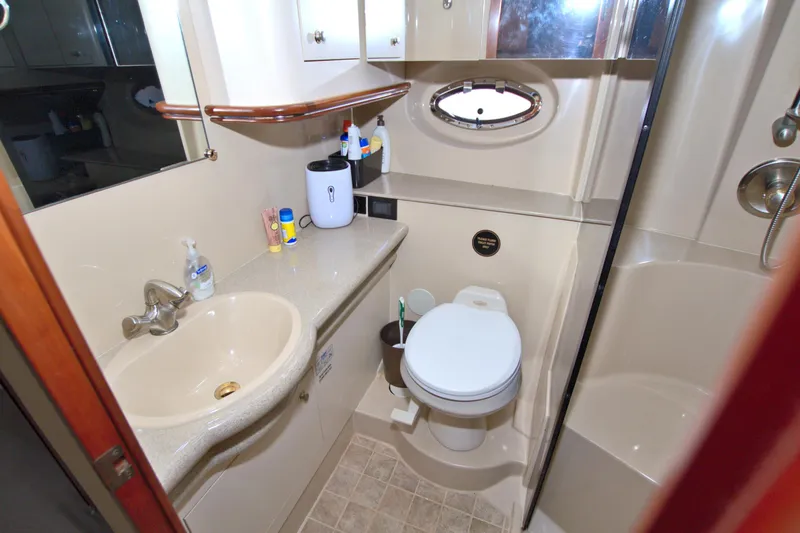 Slide: The Image of Bathroom interior of 2004 Cruisers Yachts 370 Express, featuring sink, toilet, and shower. - 41
