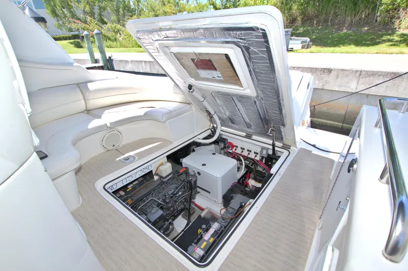 Slide: The Image of 2004 Cruisers Yachts 370 Express engine compartment with open hatch, showcasing interior components. - 44