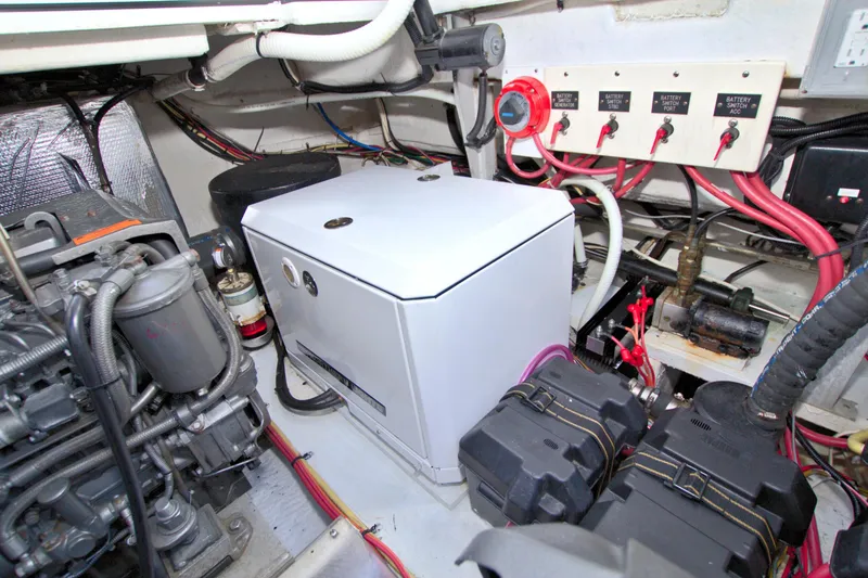 Slide: The Image of Engine room of 2004 Cruisers Yachts 370 Express with generator and battery switches. - 48