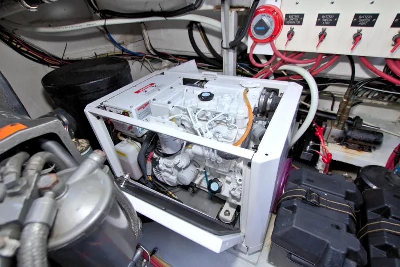 Slide: The Image of Engine room of 2004 Cruisers Yachts 370 Express with visible generator and wiring. - 50