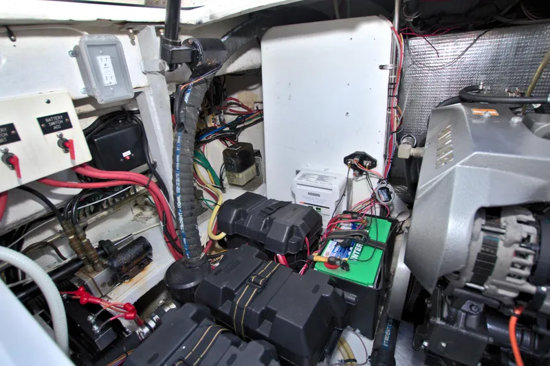 Slide: The Image of Engine room of 2004 Cruisers Yachts 370 Express, showcasing wiring and battery systems. - 52