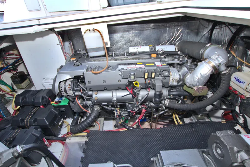 Slide: The Image of Engine compartment of a 2004 Cruisers Yachts 370 Express, showcasing detailed mechanical components. - 54