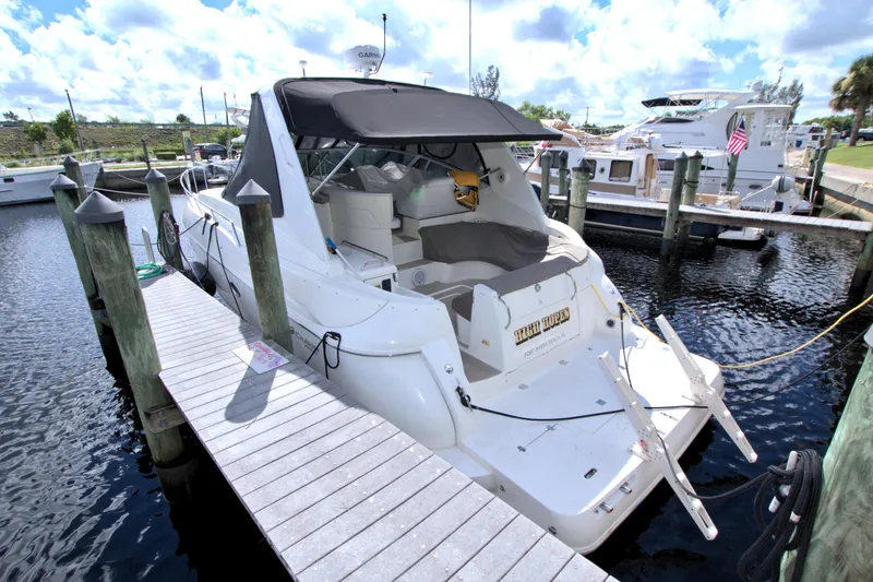 Slide: The Image of 2004 Cruisers Yachts 370 Express docked at marina, featuring sleek design and spacious deck. - 6