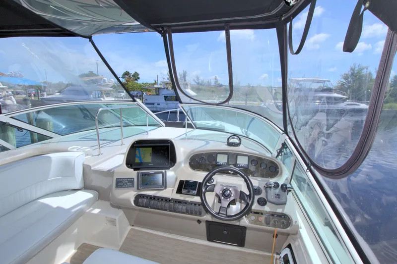 Slide: The Image of Interior view of 2004 Cruisers Yachts 370 Express helm with navigation equipment and steering wheel. - 18