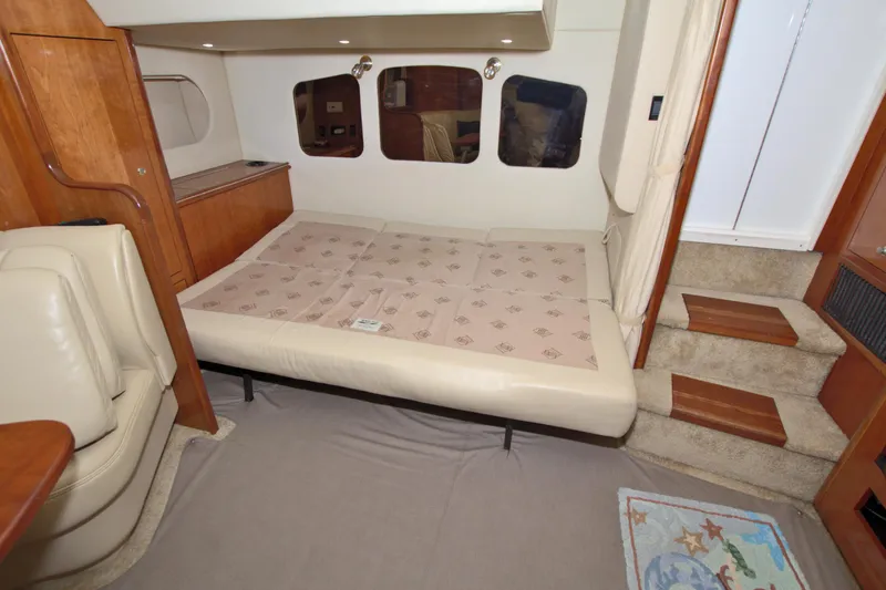 Slide: The Image of Interior cabin of 2004 Cruisers Yachts 370 Express with convertible bed and wooden accents. - 33