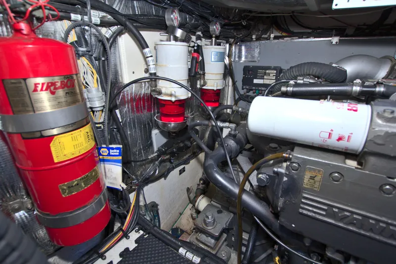 Slide: The Image of Engine room of 2004 Cruisers Yachts 370 Express with fire extinguisher and mechanical components. - 58