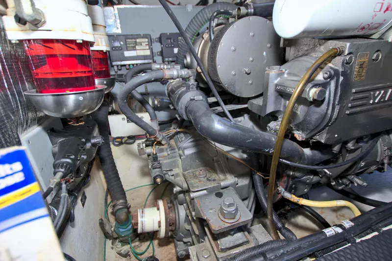Slide: The Image of Engine compartment of 2004 Cruisers Yachts 370 Express, showcasing mechanical components and wiring. - 59