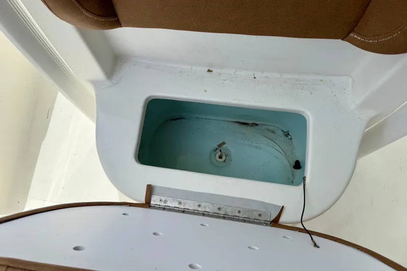Slide: The Image of Livewell compartment in a 2015 Sea Hunt Ultra 234 boat, featuring a clean interior. - 12
