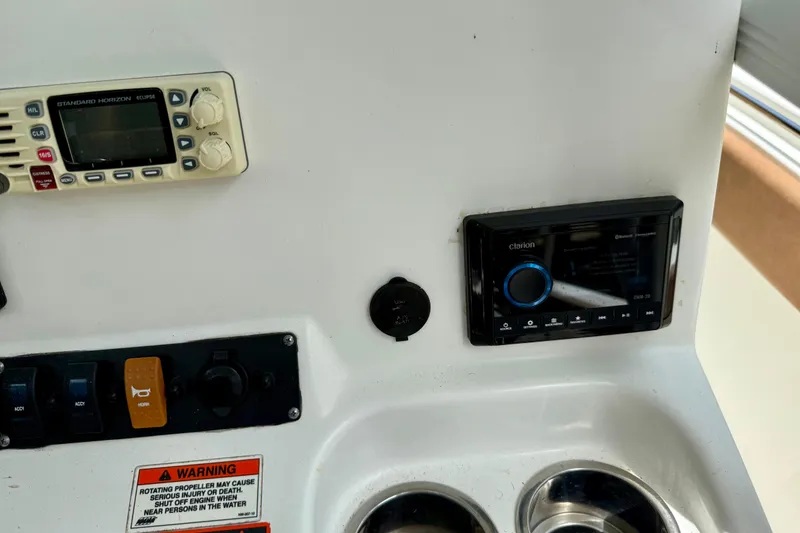 Slide: The Image of 2015 Sea Hunt Ultra 234 dashboard with radio and control panel. - 16