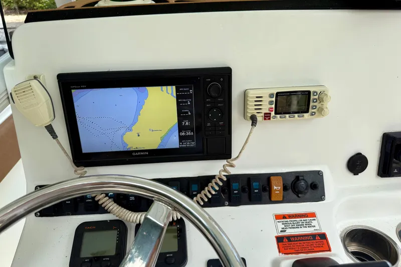 Slide: The Image of Dashboard of 2015 Sea Hunt Ultra 234 with Garmin GPS and radio controls. - 17
