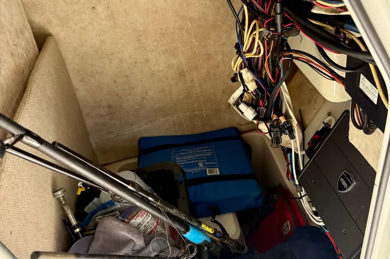 Slide: The Image of Interior of a 2015 Sea Hunt Ultra 234 boat showing storage and wiring. - 19
