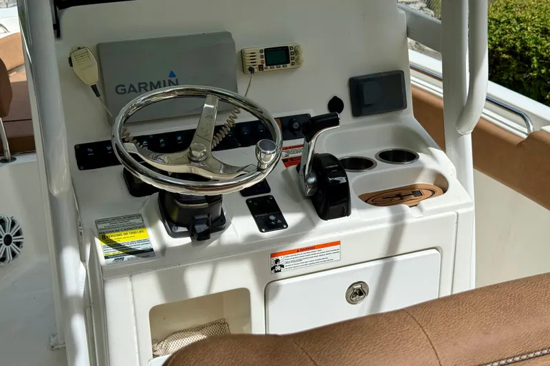 Slide: The Image of 2015 Sea Hunt Ultra 234 boat console with Garmin navigation and steering wheel. - 20