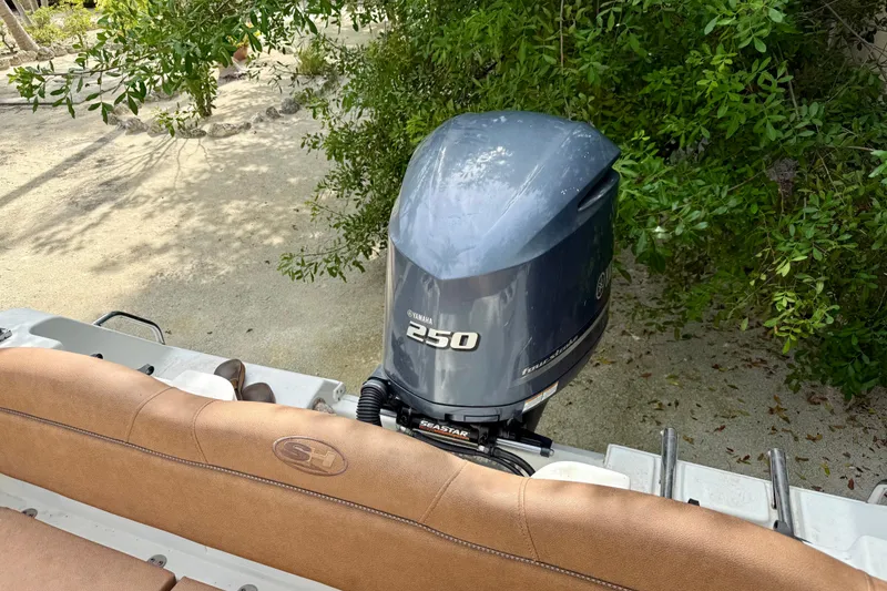 Slide: The Image of 2015 Sea Hunt Ultra 234 boat with Yamaha 250 outboard motor, surrounded by greenery. - 22