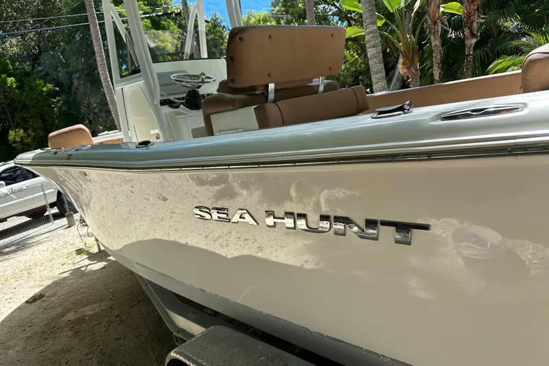 Slide: The Image of 2015 Sea Hunt Ultra 234 boat with sleek design, parked outdoors. - 27