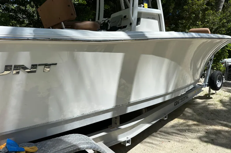 Slide: The Image of 2015 Sea Hunt Ultra 234 boat on trailer, side view in sunlight. - 30