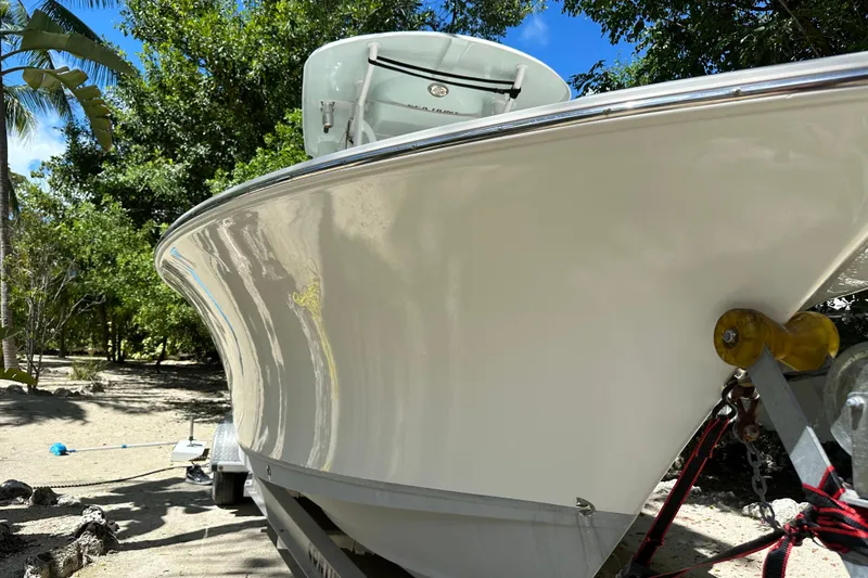 Slide: The Image of 2015 Sea Hunt Ultra 234 boat on trailer, surrounded by trees and blue sky. - 31