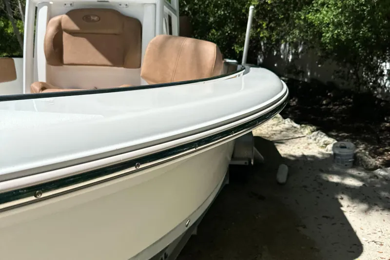 Slide: The Image of 2015 Sea Hunt Ultra 234 boat with tan seating, docked outdoors. - 34