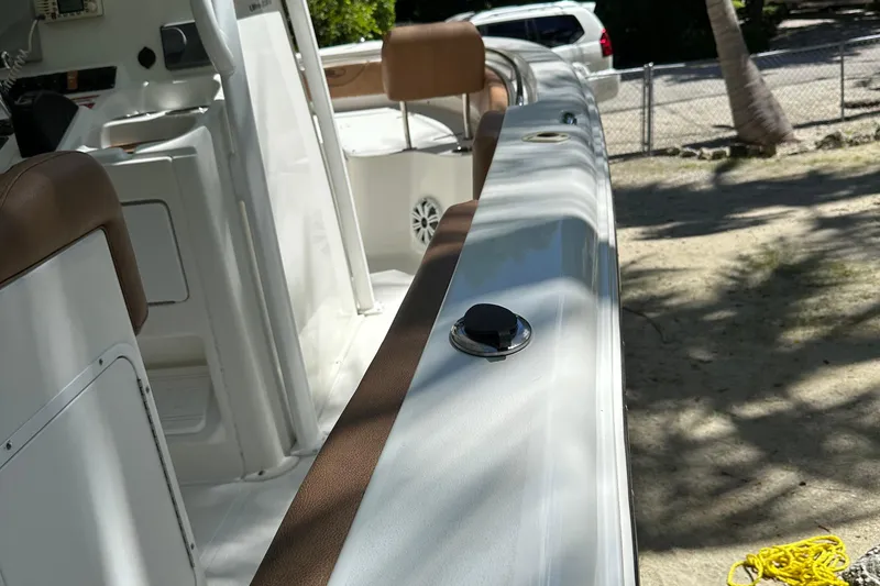 Slide: The Image of 2015 Sea Hunt Ultra 234 boat interior with brown seating and white deck. - 35