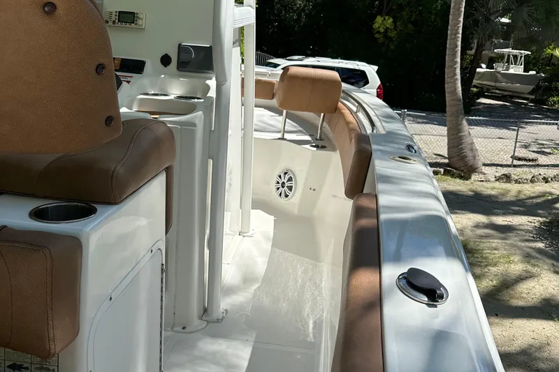 Slide: The Image of 2015 Sea Hunt Ultra 234 boat interior with brown seating and white deck. - 38