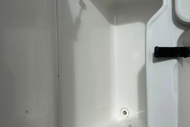 Slide: The Image of Interior view of a 2015 Sea Hunt Ultra 234 boat, featuring a clean white surface. - 43