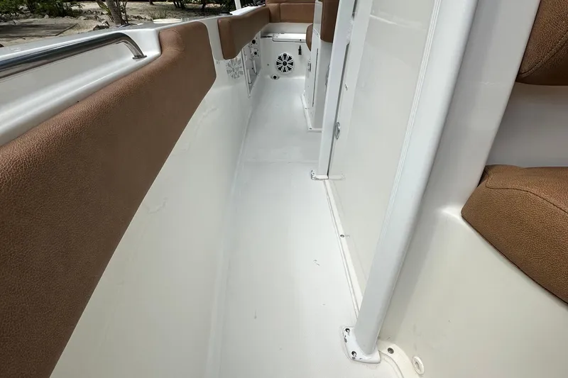 Slide: The Image of Interior view of 2015 Sea Hunt Ultra 234 boat with brown seating and white flooring. - 44