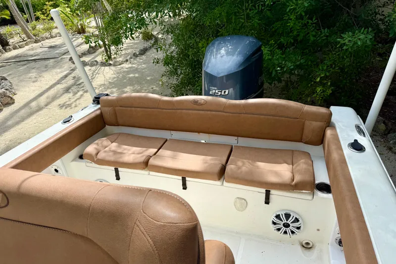 Slide: The Image of 2015 Sea Hunt Ultra 234 boat interior with tan seating and Yamaha 250 engine. - 5