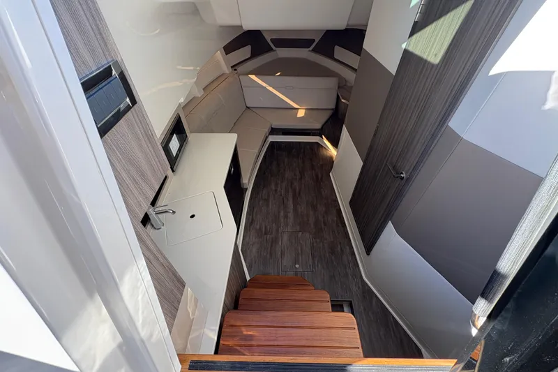 Slide: The Image of Interior of 2026 Sea Ray Sundancer 370 Outboard, featuring modern design and wood accents. - 16