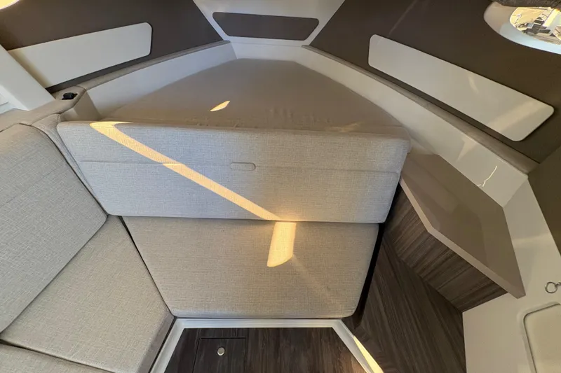 Slide: The Image of 2026 Sea Ray Sundancer 370 Outboard cabin interior with modern seating and sleek design. - 17