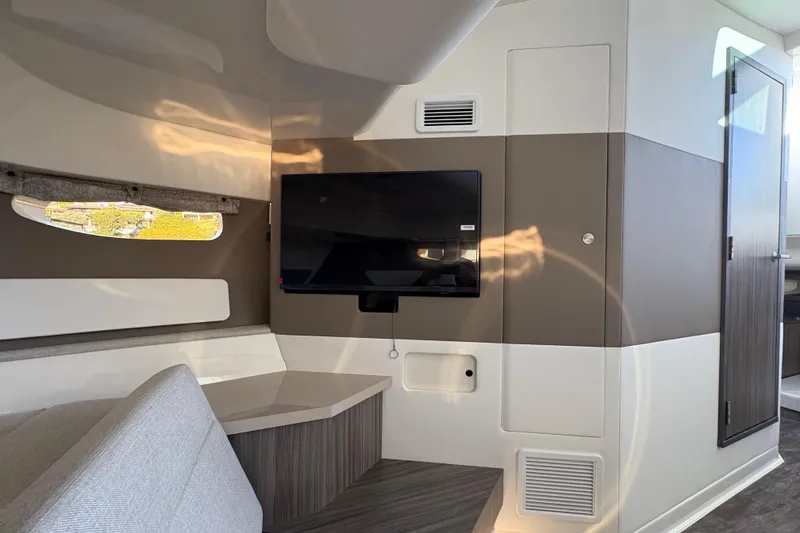 Slide: The Image of Interior of 2026 Sea Ray Sundancer 370 Outboard with modern design and mounted TV. - 18