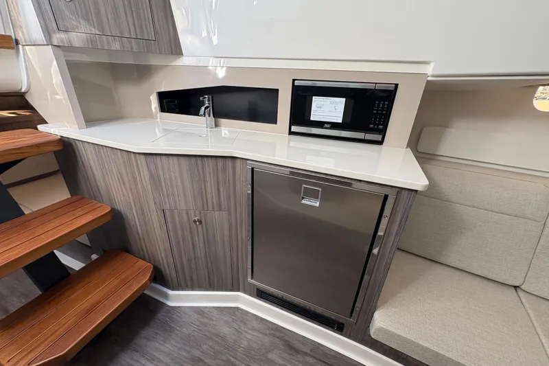 Slide: The Image of Modern galley in 2026 Sea Ray Sundancer 370 Outboard with microwave and fridge. - 19