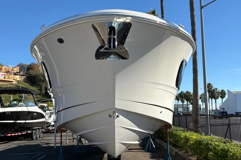 Slide: The Image of 2026 Sea Ray Sundancer 370 Outboard boat displayed outdoors on a sunny day. - 2